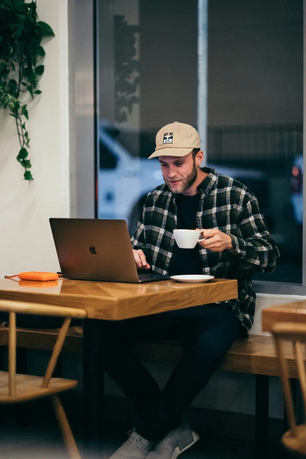 Man working on a laptop in a cafe, counseling for men in Charlotte, NC