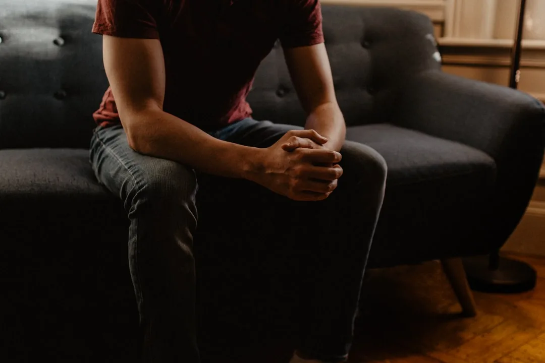 Man sitting and reflecting, representing therapy for men in Charlotte, NC